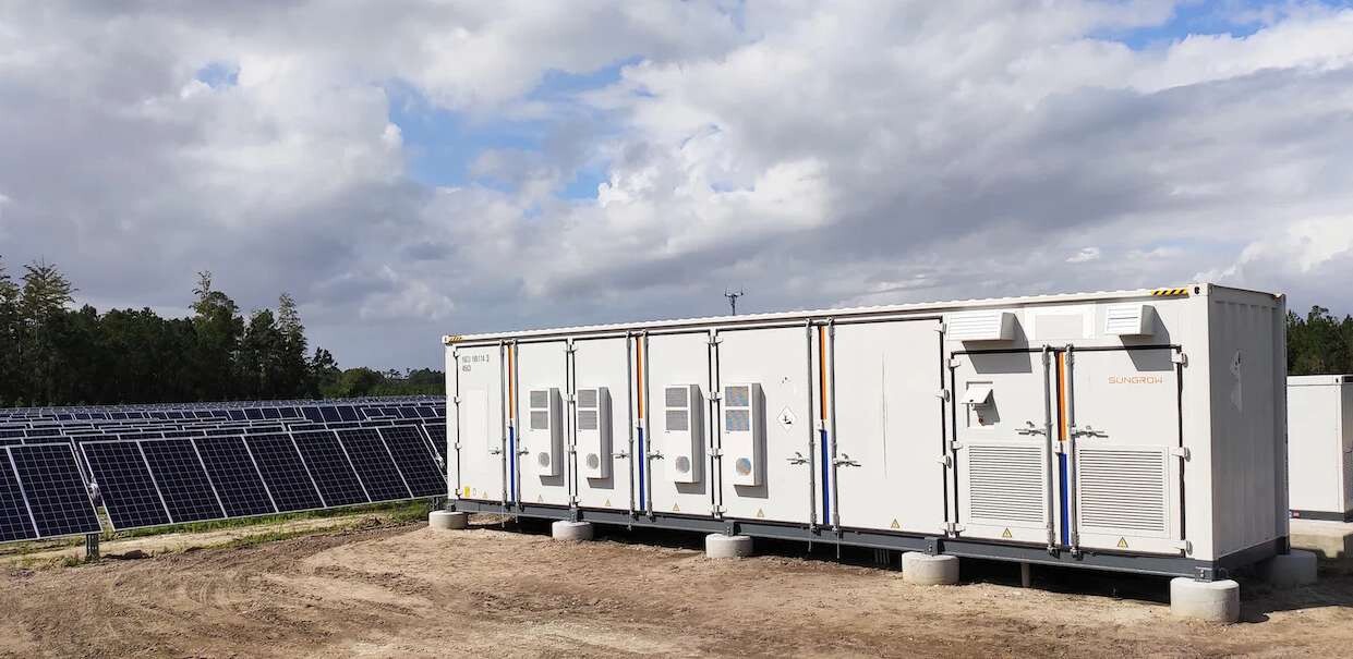 Containerized battery energy storage system beside a solar installation